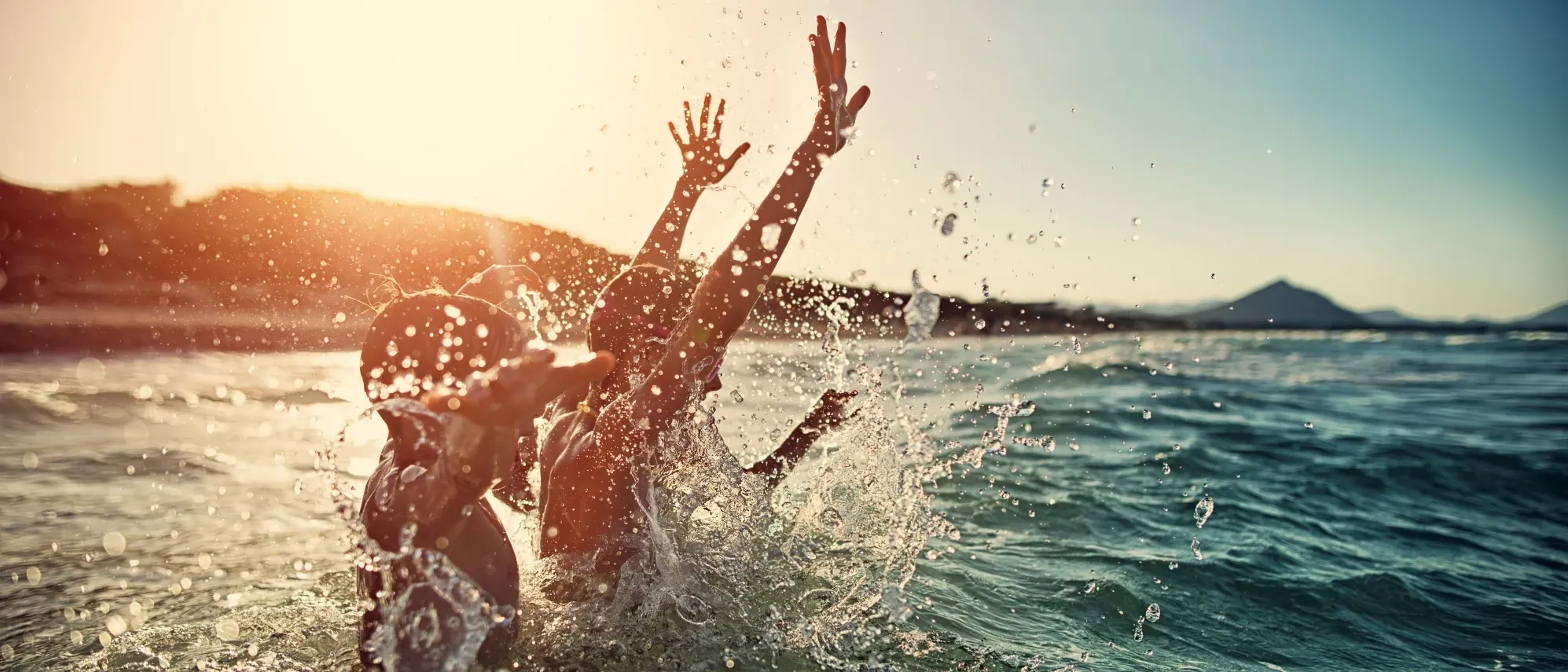 Des enfants s'éclaboussent dans la mer