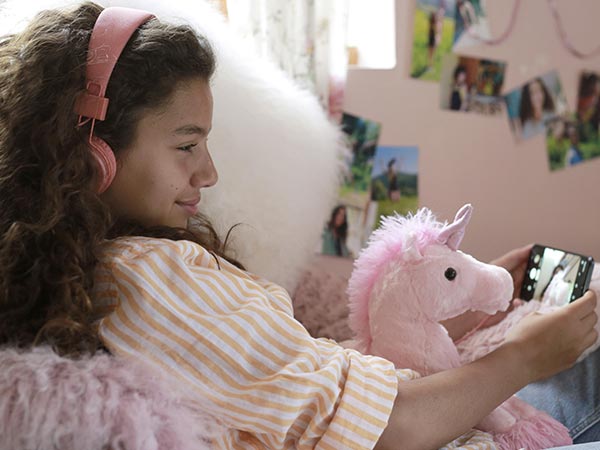 une jeune fille se photographie avec son doudou