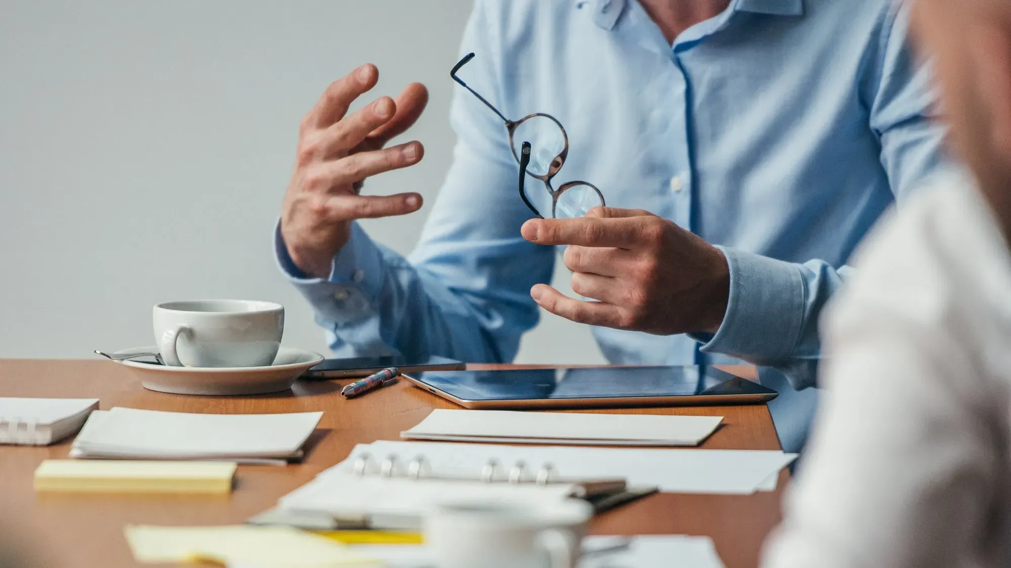 Close-up on the hands of a man and a woman at a meeting