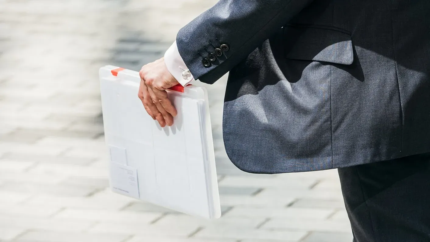A man walking with a briefcase in the street