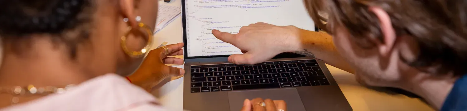 Un homme et une femme sont devant un ordinateur