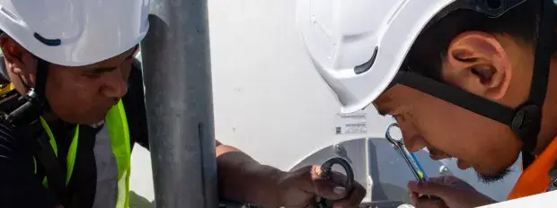 Deux hommes installent une antenne 5G