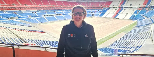 An Orange employee before a stadium